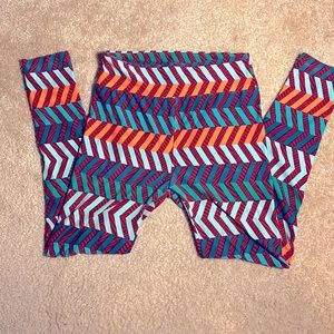 Lularoe geometric striped leggings, in shades of salmon, teal, and turquoise